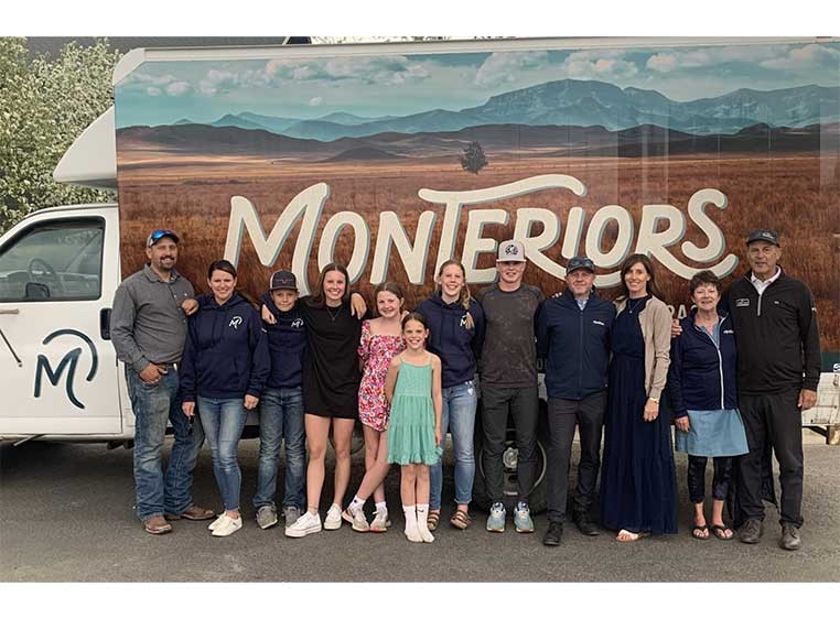 Company staff posing for a photo with the company truck